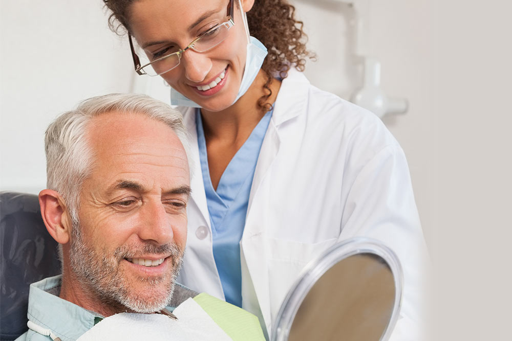 Dentist and happy patient having conversation
