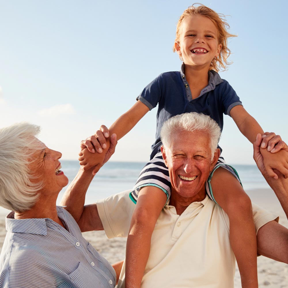 Grandparents Carrying Grandson On Shoulders