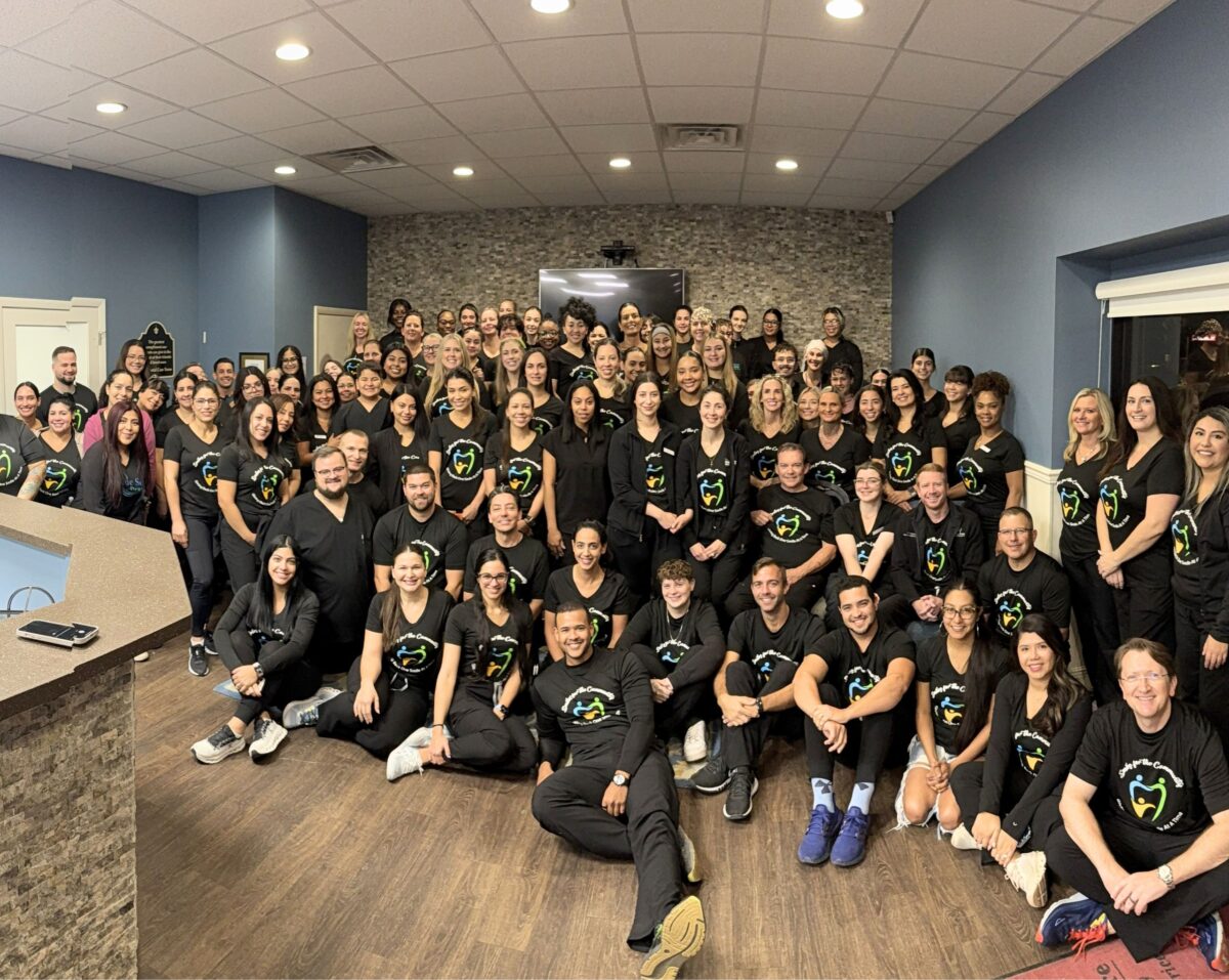 A large group of dental professionals posing together