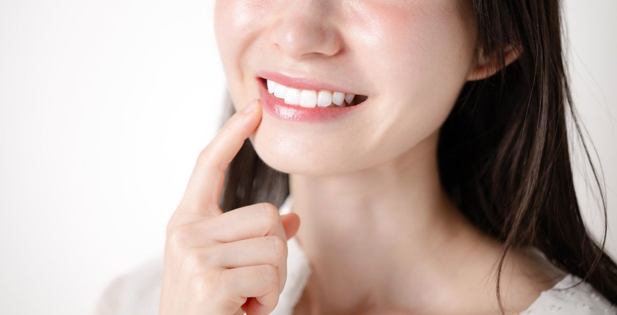 A woman pointing at her teeth