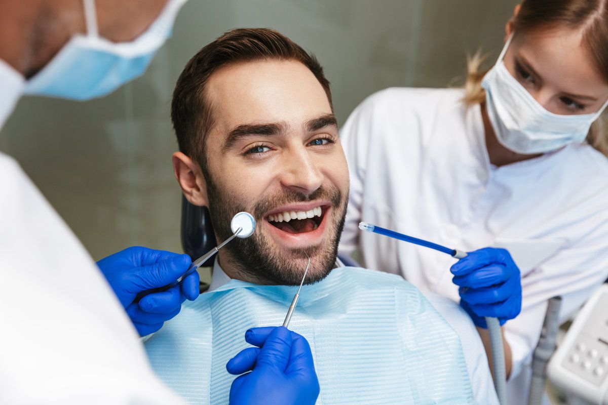 smiling man inside dental clinic