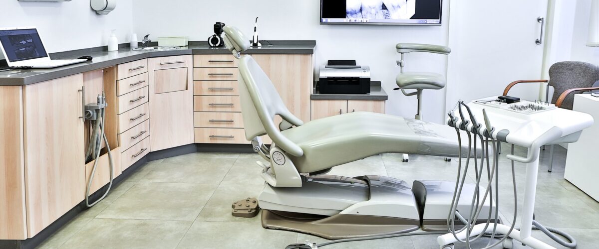 Modern dental treatment room with exam chair