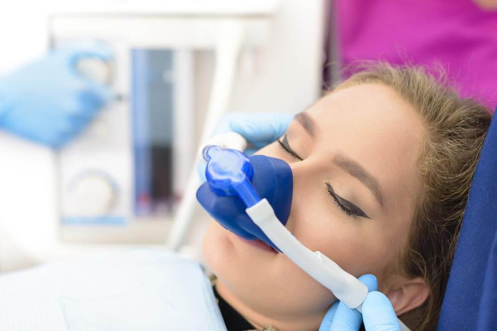 woman getting inhalation sedation at dental clinic